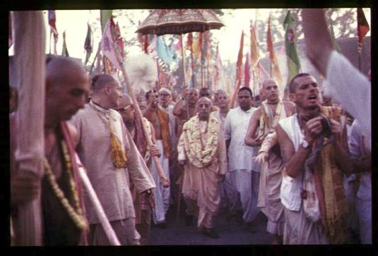 Srila Prabhupada with unbrella etc.